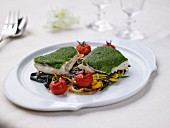 Bass fillets coated with greens,fettucinis with vegetables,squid ink pasta with roasted tomatoes