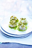 Scallops with crushed pistachios and steamed zucchini slices