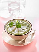 Creamed lettuce soup with slices of smoked halibut