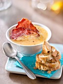 Creamed vegetable soup with crisp bacon,garlic toasts