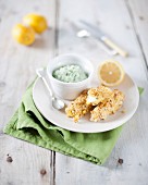 White fish fingers with green sauce