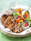 Pork chops marinated with parsley and vegetable brochettes