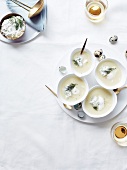 Cream of white asparagus soup with herby cream cheese mousse and quail's eggs