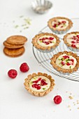 White chocolate,raspberry and crushed pistachio tartlets