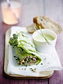 Roast beef and lettuce wrap with white dressing