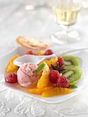Fresh fruit salad with strawberry ice cream and almond tuile