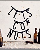 The words 'Let's Go Nuts' written on a wall