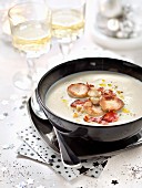 Cream of cauliflower soup with white poultry sausages, chorizo and macadamia nuts