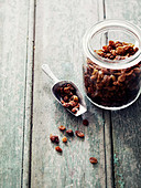 Jar and scoopful of raisins