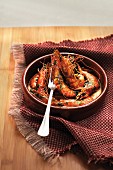 Cassolette of gambas with herbs and orange