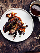 Roasted guinea fowl in red wine with mushrooms