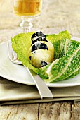 Potato papillote with black truffles on a savoy cabbage leaf