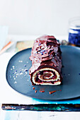 Sponge cake roll with chocolate cream and cherries
