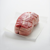Raw beef roast on a white background