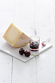 Portion of sheep's milk cheese and black cherry jam