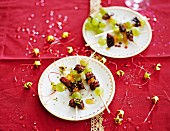 Duck in honey and crushed pistachios, candied orange and white grape brochette