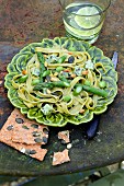 Tagliatelles with green asparagus, broad beans, , cheese and herbs, squash seed crackers