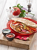 Chicken and multicolored pepper kebab, pepper and ketchup sauce