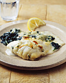 Sole au gratin with spinach leaves