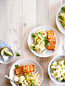 Potato salad with cream and herbs, grilled salmon steak, endive salad with red apple