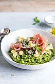 Pea risotto with cauliflower, basil and raw ham