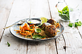 Chicken meatballs, semolina with carrots and spinach, yoghurt sauce