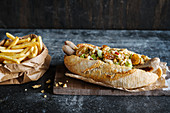 Hot dog with chicken sausages and Waldorf salad served with french fries
