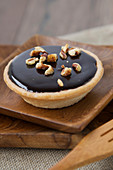 Chocolate Tartlets Sprinkled With Crushed Pine Nuts