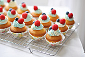 Cupcakes Topped With Raspberries And Blueberries