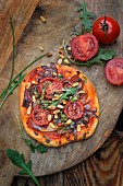 Tomato, red onion and pine nut pizza