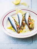 Raw sardines stuffed with thinly chopped vegetables and with olive oil and lemon