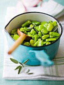 Saucepan of broad beans with sage