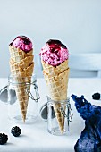 Cones of ice cream cones with blackberry coulis