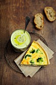 Slice of broccoli-goat's cheese quiche, pureed peas with olive oil