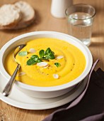 Cream of yellow carrot and butternut squash soup with almonds and corn lettuce