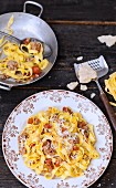 Tagliatelles with two meats, peeled tomatoes and grated parmesan
