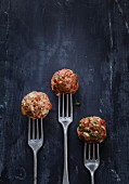 Raw meatball trio on forks