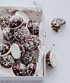 Meringue balls coated with dark chocolate and grated coconut