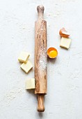 Rolling-pin, eggs and pieces of butter