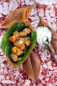 Banana and pineapple fritters with grated coconut
