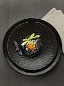 Squid ink spaghettis, green asparagus tops, sprouts and salmon roe