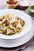 Reginette pasta with courgettes, sun-dried tomatoes and parmesan