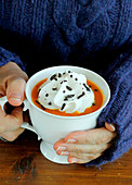 Cream of pumpkin soup with whipped cream and thinly chopped truffles