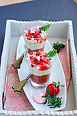 Stewed rhubarb, basil cream, strawberry and crushed meringue individual desserts
