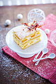 Slice of peaches in syrup and coconut cake,caramel decoration