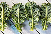 Kale leaves on wooden surface