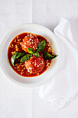 Italian soup with tomatoes, artichokes, cheese and basil