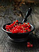 Redcurrants in a rustic wooden container