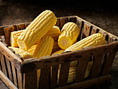 Box of fresh, peeled corn on the cob