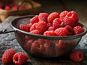 Raspberries in metal sieve
